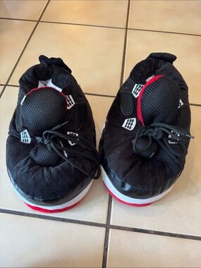 Air Jordan Kids Black and Red fuzzy slippers.